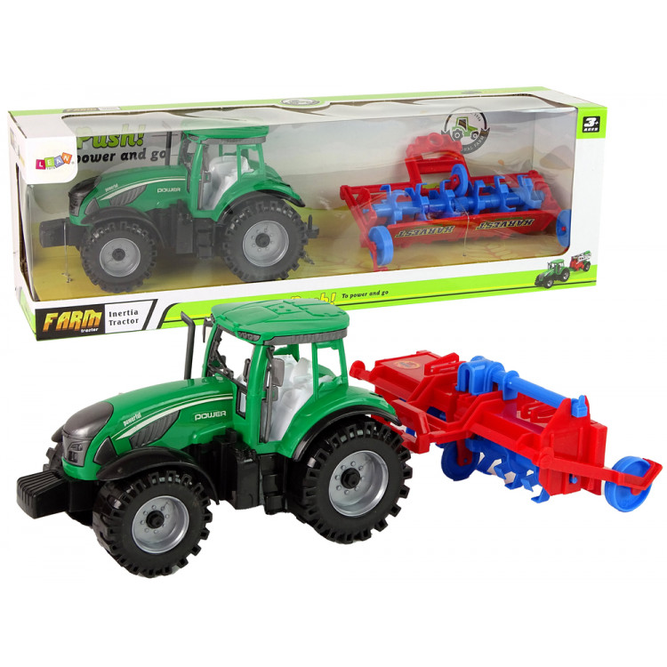 Zelený traktor s červeným pluhom