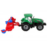 Zelený traktor s červeným pluhom